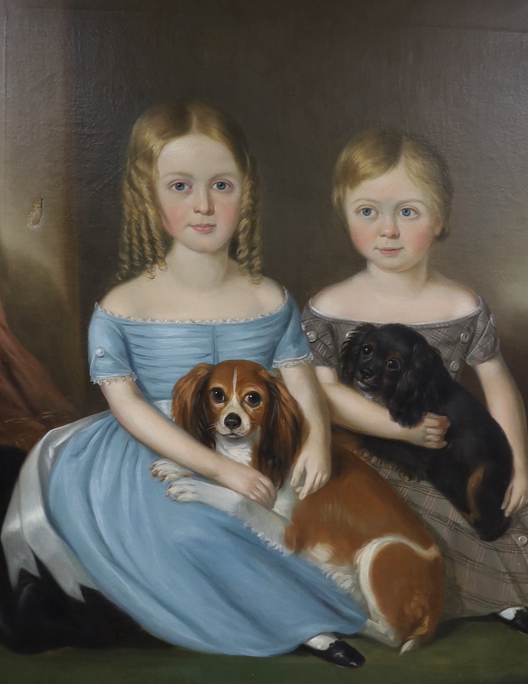 Mid 19th century English School, Portrait of two children seated with their King Charles Spaniels, oil on canvas, 91 x 74cm